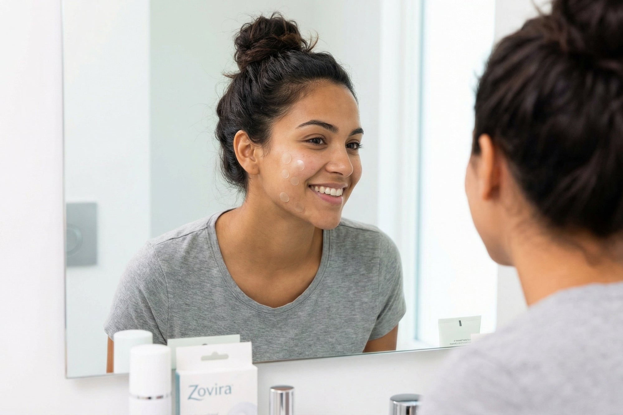 Woman looking at Zovita skincare products in front of a mirror