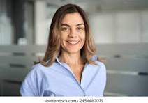 Woman in a blue shirt standing in an indoor setting