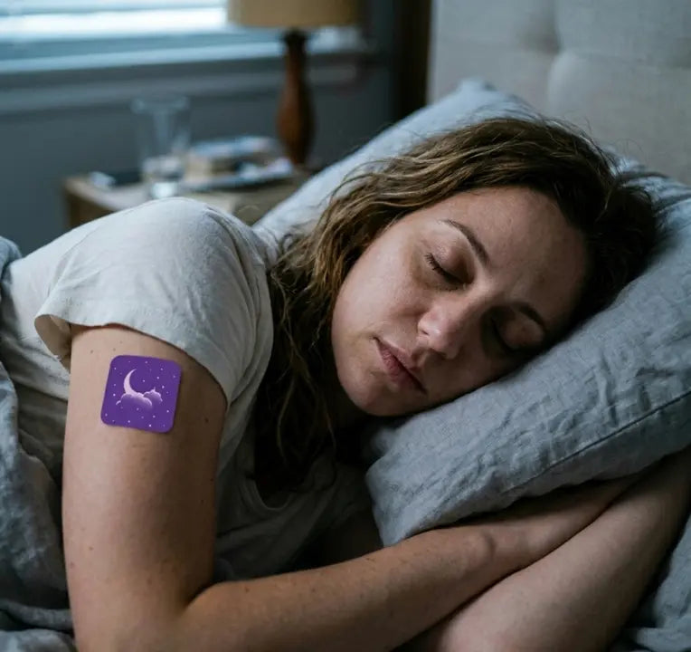 Woman sleeping peacefully on her side wearing purple Zovira transdermal sleep patch on upper arm, experiencing deep restful sleep with magnesium and valerian root after 2 months of use